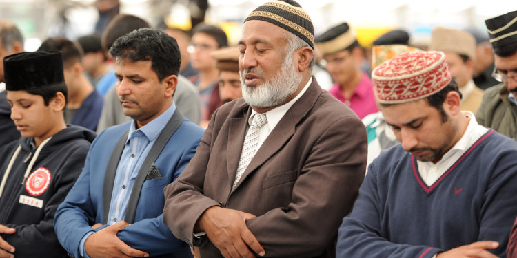 Ahmadiyya Muslims gather for Friday prayers in the main tent as they join up to 30,000 Muslims to pledge allegiance to the Caliph during Jalsa Salana UK 2014 in Alton, Hampshire.